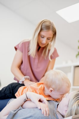 chiropractor adjusting toddler